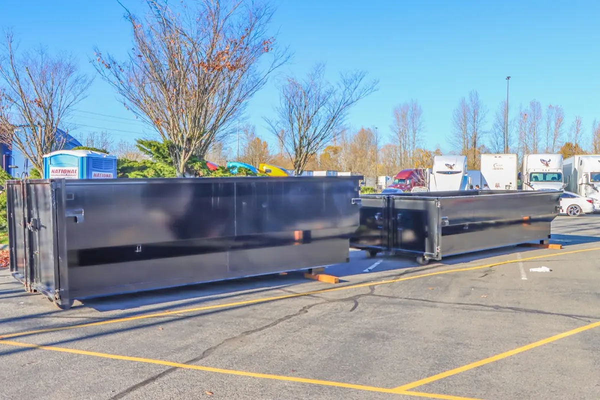 Professional dumpster rental service with roll-off container on residential driveway in Glennville